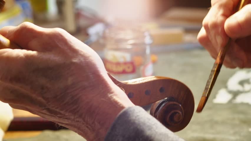 Luthier restoring old musical instrument varnish | Shutterstock HD Video #1101418631