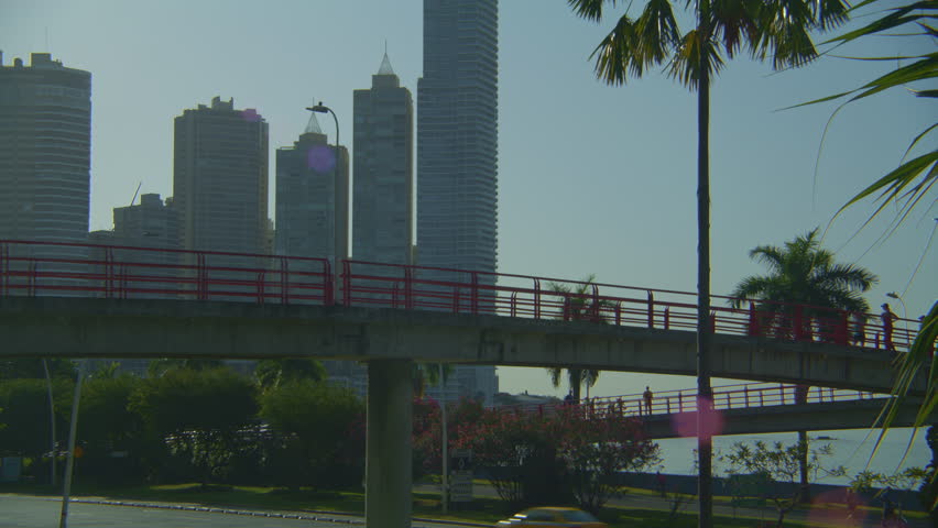People running in the morning and walking thru a pedestrian bridge in Panama City Central America 
