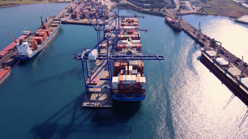 Container ship loading and unloading in deep sea port, Aerial view