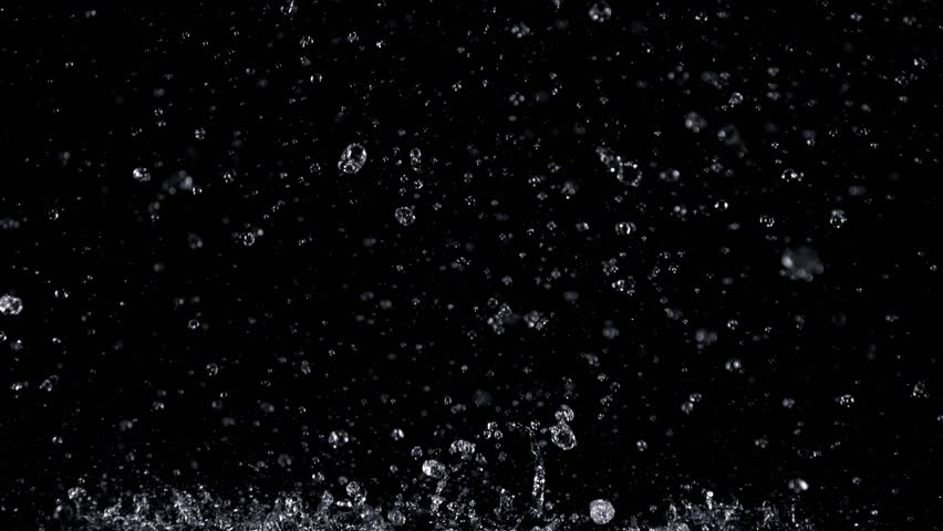 Super Slow Motion Shot of Real Rain Drops Falling Down Isolated on Black Background at 1000fps.