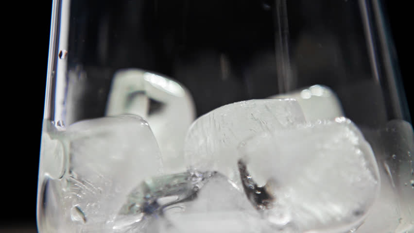 Fruit Juice with Ice Cubes Inside Glass Cup Closeup. Fresh Orange Drink with Natural Liquid Vitamins in Glassware for Healthy Yummy Diet. Good Modern Menu with Chilled Beverage Made of Vivid Citron
