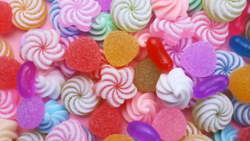 Colored  candies,  mix of sweets and lollipops rotating. Sweet sugar dessert.  Festive background for holiday or children's birthday. Royalty-Free Stock Footage #1101430889