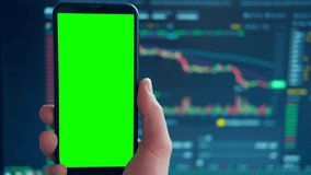 Black phone with blank mockup screen on rising stock graph. Closeup hand showing smartphone isolated green display. Online banking, Fund App use. Financial analyst on Invest Market. Bank collapse 2023 - Powered by Shutterstock - Get 15% off with code: PIKWIZARD15