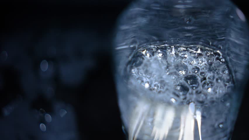 Clean drinking water from the tap. Slow motion. A glass of water, a beautiful frame. Concept: thirst, saving resources, water use, utility prices, flushing money down the drain. | Shutterstock HD Video #1101438091