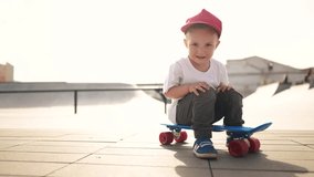 child boy close-up with a skateboard. boy in red cap with a skateboard on the playground portrait. skateboarder child outdoors sun glare. kid skateboarder looking lifestyle at the camera - Powered by Shutterstock - Get 15% off with code: PIKWIZARD15