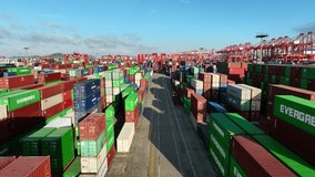 Aerial view of the sea cargo port and container terminal of Yangshan port in Shanghai at night.Loading and unloading container ships in deep water ports. - Powered by Shutterstock - Get 15% off with code: PIKWIZARD15