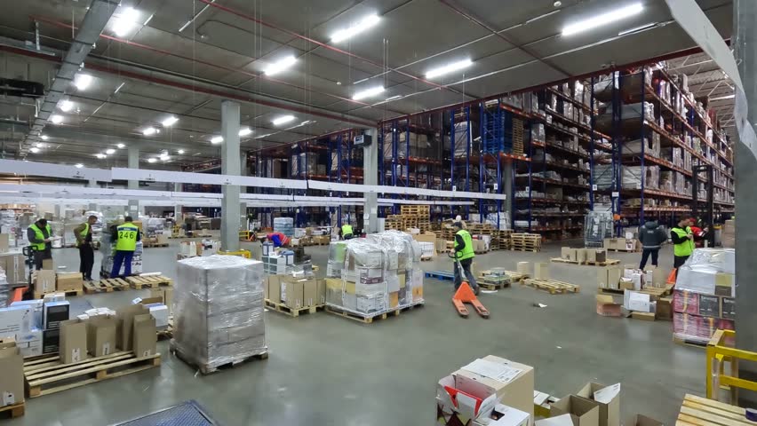 People work in a warehouse timelapse. People work in a large warehouse. Timelapse in a modern warehouse. Work with a modern warehouse Royalty-Free Stock Footage #1101439199