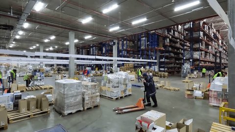 People work in a warehouse timelapse. People work in a large warehouse. Timelapse in a modern warehouse. Work with a modern warehouse วิดีโอสต็อก