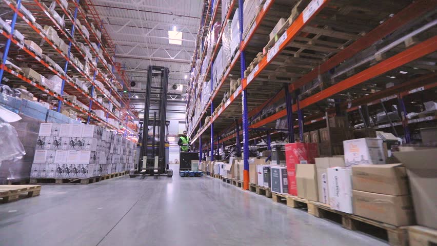 Special equipment in the warehouse of the factory. Lots of forklifts touring the warehouse. Modern loaders in a large warehouse Royalty-Free Stock Footage #1101439209