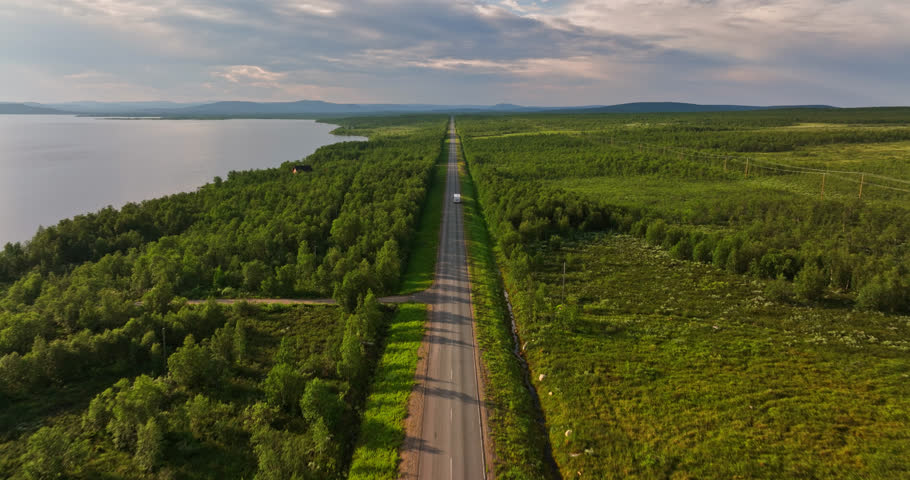 Aerial view following a caravan driving in arctic tundra nature on a summer evening Royalty-Free Stock Footage #1101441571