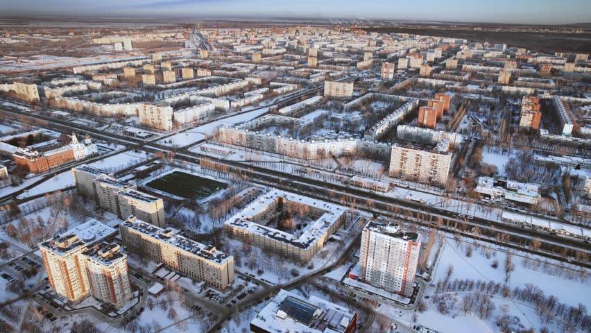 Aerial view. Winter panorama of the city of Tolyatti in the Samara region. Snow-covered streets of a provincial and industrial Russian city. Royalty-Free Stock Footage #1101444457