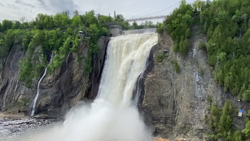 The Montmorency Falls (Chute Montmorency) large waterfall on Montmorency River where it drops into the Saint Lawrence River in Quebec, Canada. Protected within Montmorency Falls Park.