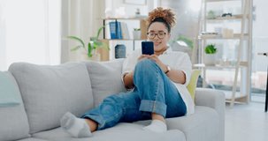 Woman, phone and texting on sofa to relax with social media, meme and communication internet in house. Gen z girl, smartphone and chat with app ux, tech or watch video with smile in home living room
