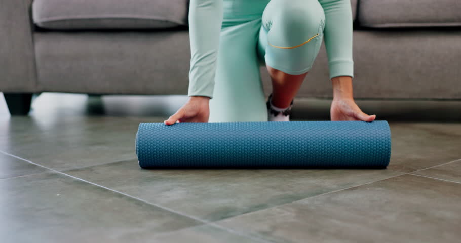 Fitness, yoga and woman rolling mat on floor for workout, wellness and healthy morning exercise at home. Closeup female prepare to start pilates training in living room, house and sports for balance Royalty-Free Stock Footage #1101450131