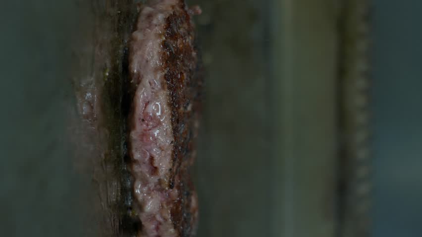 Vertical Shot Of Grilling Beef Meat For Hamburger. Street Food. Fast Food