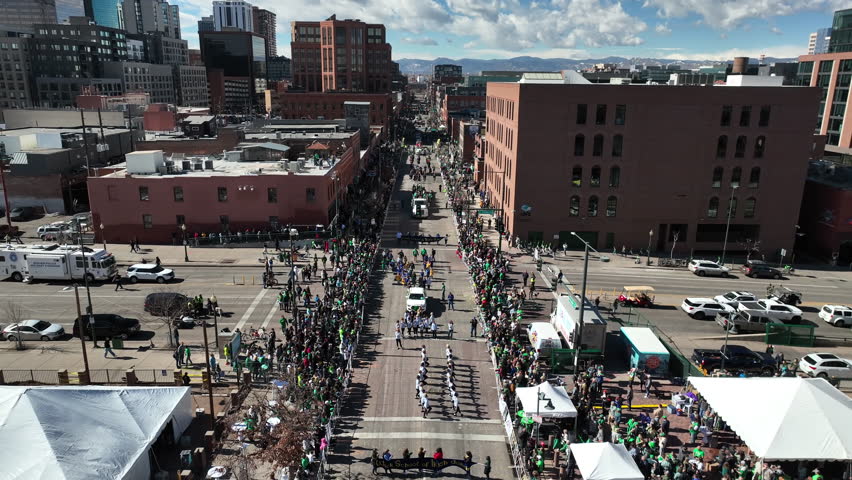 Aerial view of a parade making its way through downtown Denver, Colorado.