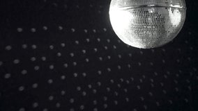 A spinning mirrored disco ball reflects light onto the wall. - Powered by Shutterstock - Get 15% off with code: PIKWIZARD15