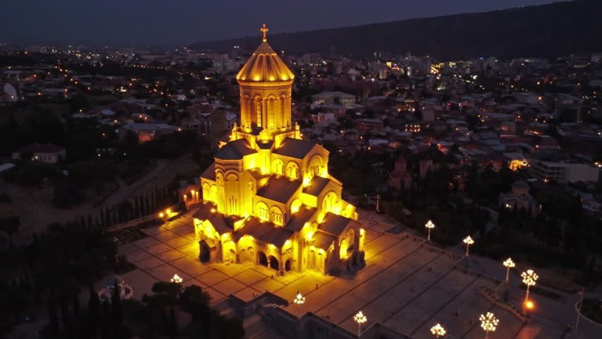 Aerial around view of Holy Trinity Cathedral or Tsminda Sameba Church in Tbilisi at night, Georgia, 4k Royalty-Free Stock Footage #1101452959