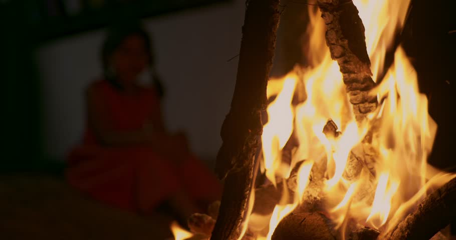 Holi celebration and little girl,  Fire, flames and red charcoal 