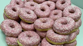 Many sweet pink donuts in one place