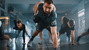 Fitness group people doing Alternating Renegade Row exercises using dumbbells while exercising in the gym - Powered by Shutterstock - Get 15% off with code: PIKWIZARD15