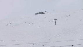 Snowy views of people skiing timelapse cable cars are moving with  interval 