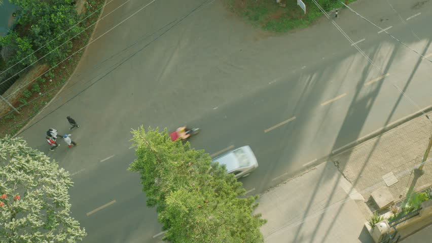 Beautiful static shot from above of a busy street with pedestrians and cars in Nairobi, Kenya, Africa. 4k high quality footage.