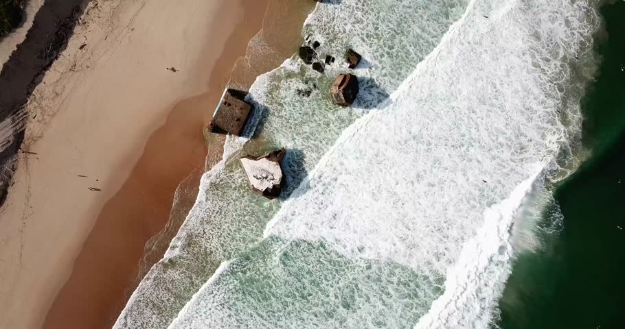 Aerial View of Capbreton Abandoned Blockhouses from World War Two on a long sandy beach in France with Ocean Waves crashing on the shore Royalty-Free Stock Footage #1101458771
