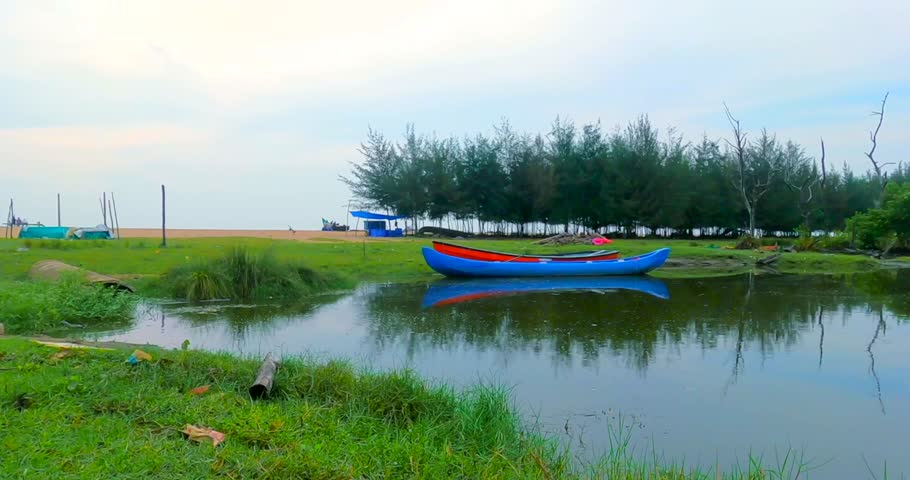 Beautiful Landscape View of Lake near Beach and two boats, blue sky water reflection
