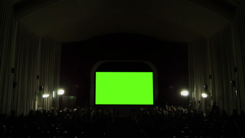 Cinema Hall with Green Screen and Blurred Audience. Zoom In. 4K Resolution. Royalty-Free Stock Footage #1101462163