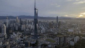 Aerial view hyperlapse 4k video of Kuala Lumpur city center view during dawn overlooking the city skyline in Federal Territory, Malaysia. Tilt up