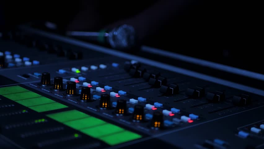 The sound engineer mixes sound on the professional sound mixer at the concert