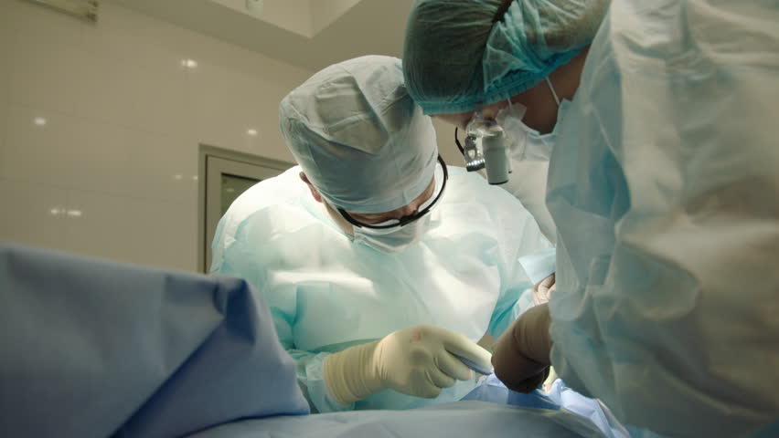 Dental surgery, dental clinic, dentist doctor and assistant in blue suits during implant operation Royalty-Free Stock Footage #1101467725