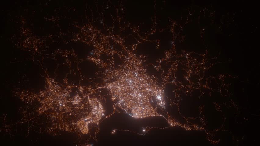 Kingston (Jamaica) aerial view at night. Top view on modern city with street lights. Camera is flying above the city, moving backward