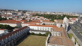 A camera drone flies backward above the Jerónimos Monastery and Maritime Museum, Lisbon, Portugal