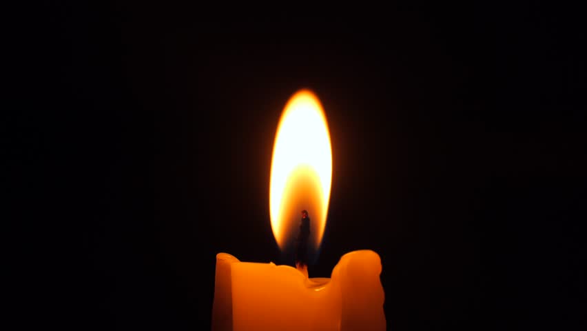 Burning Candle Wick Flame High Quality 4K Slow Motion Close-Up Macro Footage. Memorial Religious Romance Concept Dark Background.