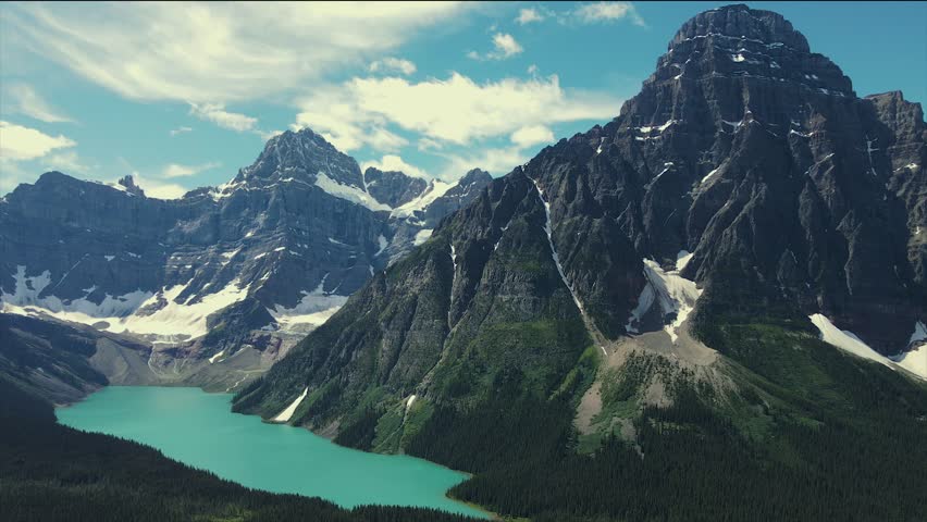 Top Cinematic aerial view to the Banff National Park. Aerial over rugged Rocky Mountain lakes in Banff National Park, Canada. Canadian Landscape and wild nature from above. 