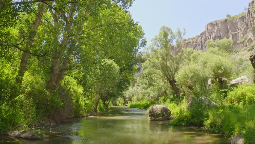 Aerial view of a Famous and popular tourist attraction of Cappadocia and Turkey - Ihlara Valley with a deep gorge and steep cliffs with hiking paths.