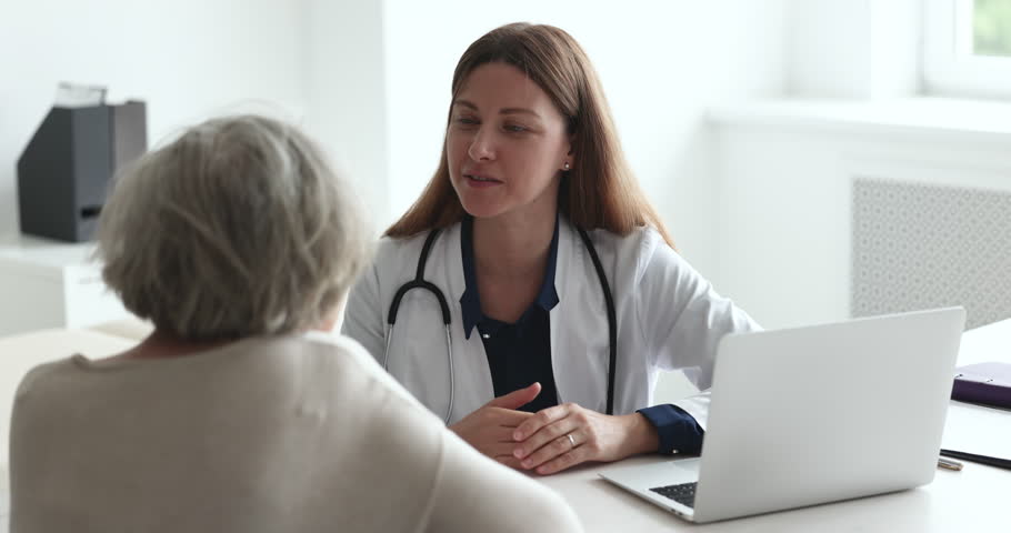 Positive physician doctor giving consultation, therapy medical advice, recommending treatment to elder senior patient, talking to listening old lady, explaining therapy Royalty-Free Stock Footage #1101476255