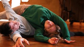 contact improvisation performed by a man and a woman. Dancer improvising an intimate dance on the floor