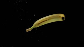 Slow motion one banana falling into transparent water on black background. Fresh fruits splashing in aquarium. Healthy food, diet, air bubbles - Powered by Shutterstock - Get 15% off with code: PIKWIZARD15