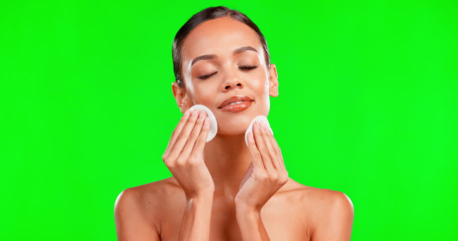 Happy woman, beauty and cotton swab on green screen for makeup removal against a studio background. Beautiful female cleaning or wiping face with swabs or pads for facial cleanse or hygiene on mockup | Shutterstock HD Video #1101484113