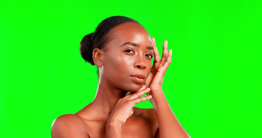 Face, skincare and a black woman on a green screen background in studio for natural or real beauty. Portrait, facial and chromakey mockup with an attractive young female touching her smooth skin | Shutterstock HD Video #1101484139