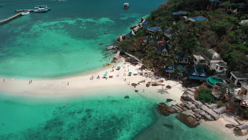 Aerial view, beach of Koh Tao in Southern Thailand with blue ocean and Koh Nang Yuan island. Summertime paradise island with thin sandy strip. Place for perfect snorkeling. High quality 4k footage Royalty-Free Stock Footage #1101485805