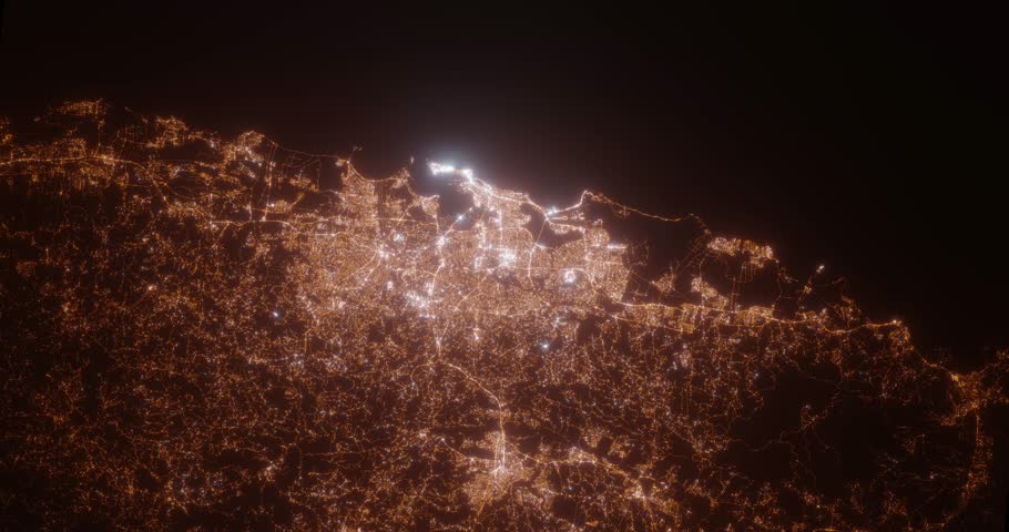 San Juan (Puerto Rico) aerial view at night. Top view on city from space. Camera is zooming in, rotating clockwise
