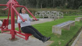 Active Woman: Exercising on Public Fitness Equipment in the Park, video