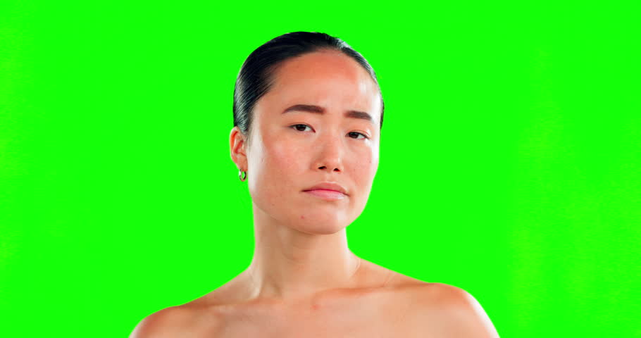 Asian woman, face and squeeze pimple on green screen in skincare for dermatology against studio background. Portrait of female with facial breakout, blackhead or grooming for acne treatment on mockup | Shutterstock HD Video #1101488563