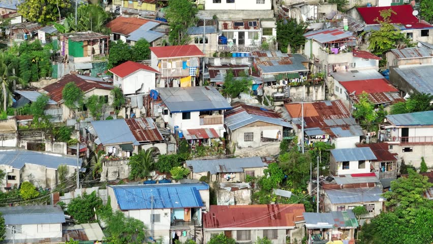 Aerial shot of the poor neighborhoods mixed in with new modern high-rises in Cebu City Philippines.