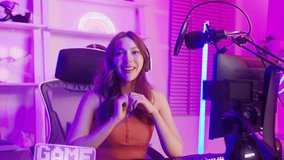 Young Asian Pretty woman Pro Gamer have live streaming , singing and chatting with her fans at home