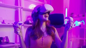 Young Asian pretty woman Pro Gamer have live streaming playing video game, using virtual reality glasses at home

